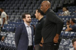 Memphis Grizzlies general manager Zach Kleiman (left) talks with Denver Nuggets general manager Calvin Booth (right)