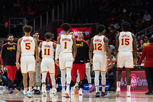 Atlanta Hawks guard Dyson Daniels (5), guard Trae Young (11), forward Jalen Johnson (1), forward De’Andre Hunter (12), and center Clint Capela (15) walk to the bench