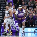 Utah Jazz guard Jordan Clarkson (00) reacts to a basket with center John Collins (20) behind him