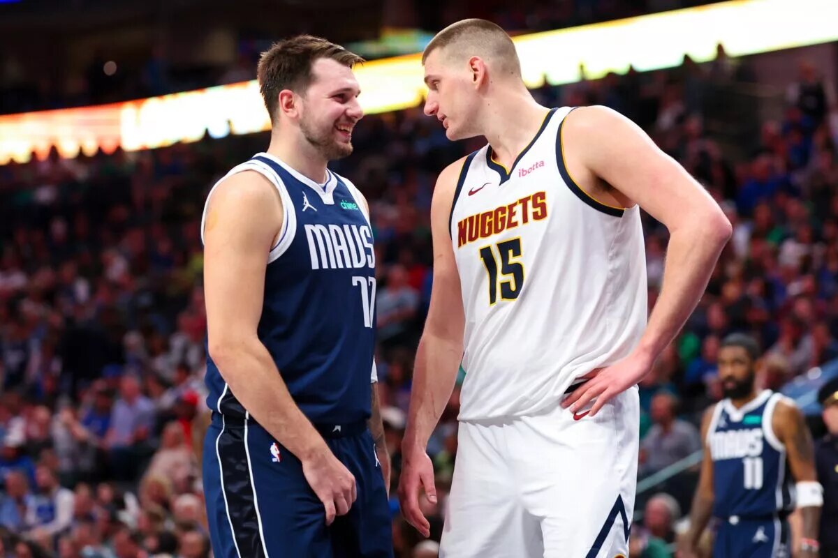 Dallas Mavericks guard Luka Doncic (77) speaks with Denver Nuggets center Nikola Jokic (15)