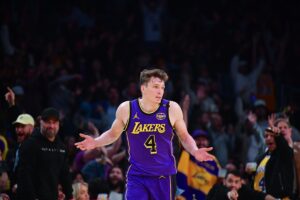 Nov 19, 2024; Los Angeles, California, USA; Los Angeles Lakers guard Dalton Knecht (4) reacts after scoring a three point basket against the Utah Jazz during the second half at Crypto.com Arena. Mandatory Credit: Gary A. Vasquez-Imagn Images