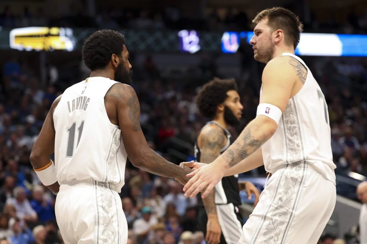 Dallas Mavericks guard Luka Doncic (77) celebrates with Dallas Mavericks guard Kyrie Irving (11)