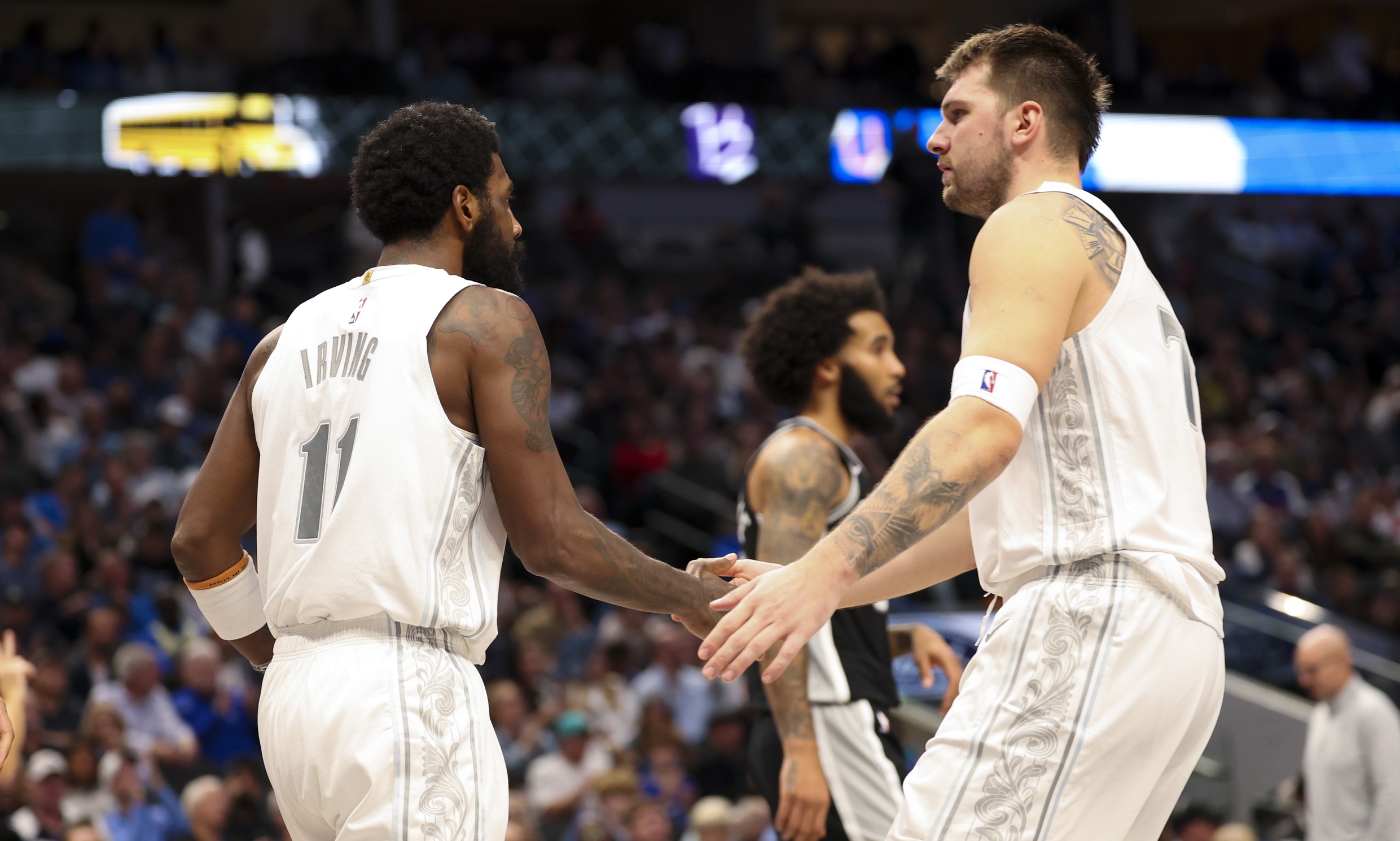 Dallas Mavericks guard Luka Doncic (77) celebrates with Dallas Mavericks guard Kyrie Irving (11)