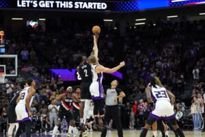 Portland Trail Blazers center Deandre Ayton (2) and Sacramento Kings forward Domantas Sabonis (11) jump for the ball