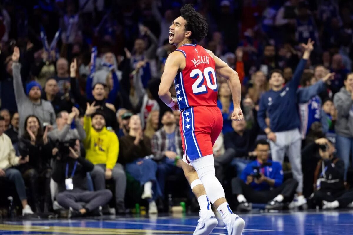 Philadelphia 76ers guard Jared McCain (20) reacts to his three pointer
