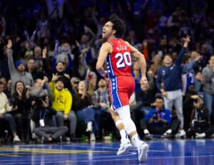 Philadelphia 76ers guard Jared McCain (20) reacts to his three pointer