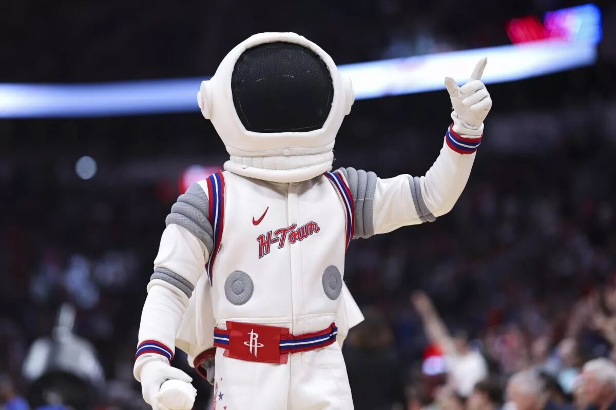 Houston Rockets mascot Dunkstronaut throws shirts to the crowd