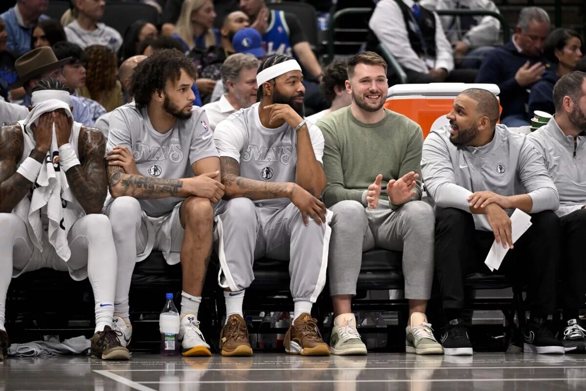 Dallas Mavericks center Dereck Lively II and forward Markieff Morris and guard Luka Doncic sit on the team bench during the second quarter of the game between the Mavericks and the New York Knicks