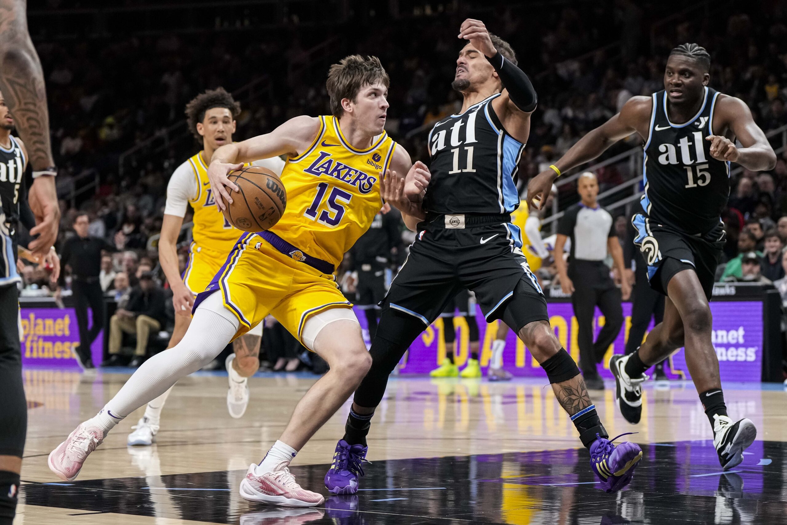 Jan 30, 2024; Atlanta, Georgia, USA; Los Angeles Lakers guard Austin Reaves (15) works against the defense of Atlanta Hawks guard Trae Young (11) during the first half at State Farm Arena. Mandatory Credit: Dale Zanine-USA TODAY Sports