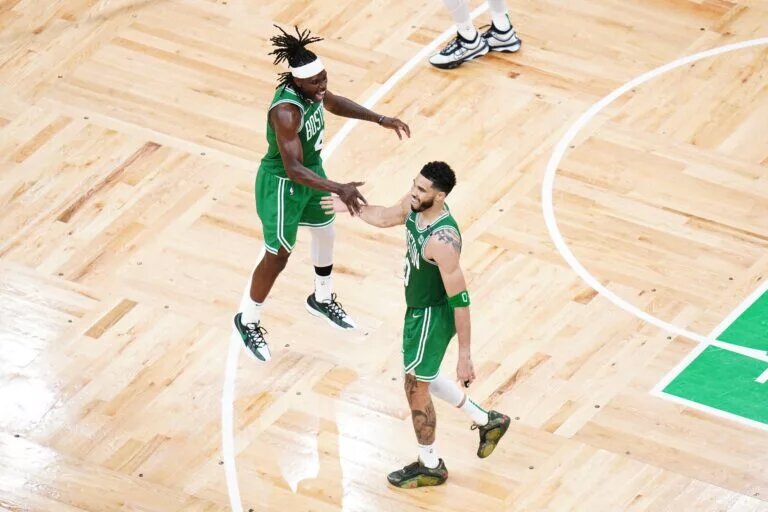 Boston Celtics Jayson Tatum with Jrue Holiday