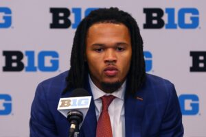 Illinois guard/forward Ty Rodgers takes a question at the podium during the 2024 Big Ten Mens Basketball media day at Donald E. Stephens Convention Center.