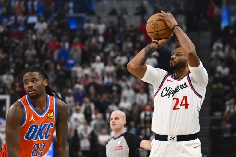 Nov 2, 2024; Inglewood, California, USA; LA Clippers guard Norman Powell (24) shoots against Oklahoma City Thunder guard Cason Wallace (22) during the first half at Intuit Dome. Mandatory Credit: Jonathan Hui-Imagn Images