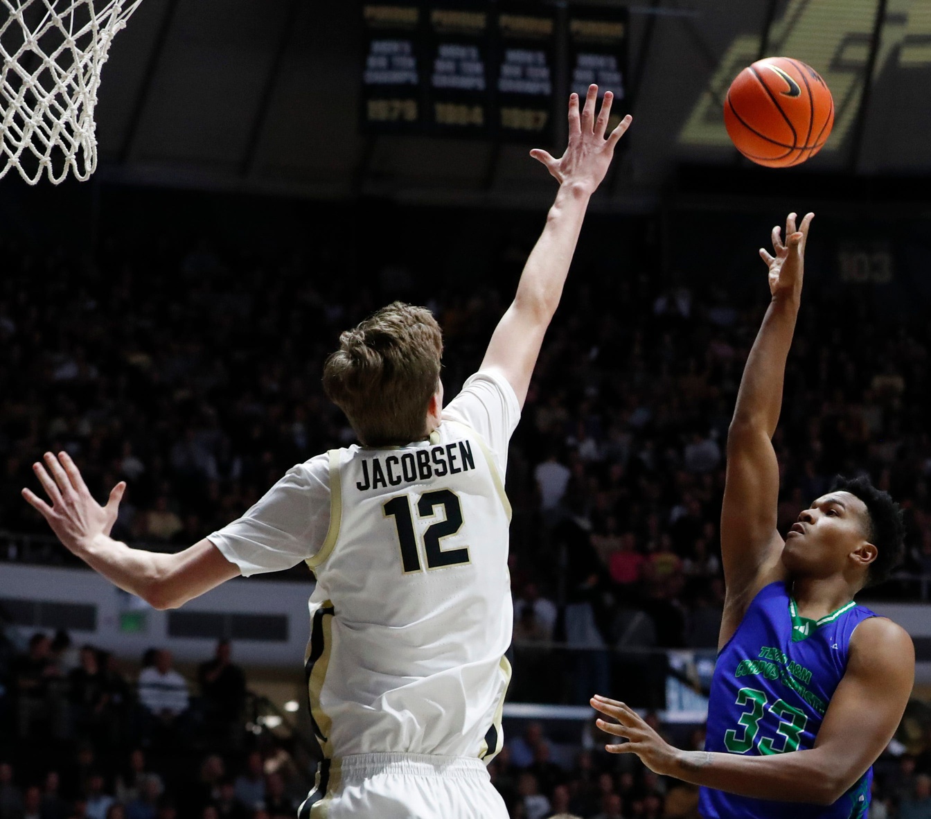 Purdue Boilermakers center Daniel Jacobsen (12) defends the shot of Texas A&M-CC Islanders forward Garry Clark (33) Monday, Nov. 4, 2024, during the NCAA men’s basketball game at Mackey Arena in West Lafayette, Ind.