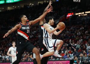 Nov 10, 2024; Portland, Oregon, USA; Memphis Grizzlies guard Yuki Kawamura (17) shoots the ball around Portland Trail Blazers forward Kris Murray (24) and Trail BlazersÕ forward Jabari Walker (34) in the second half at Moda Center. Mandatory Credit: Jaime Valdez-Imagn Images