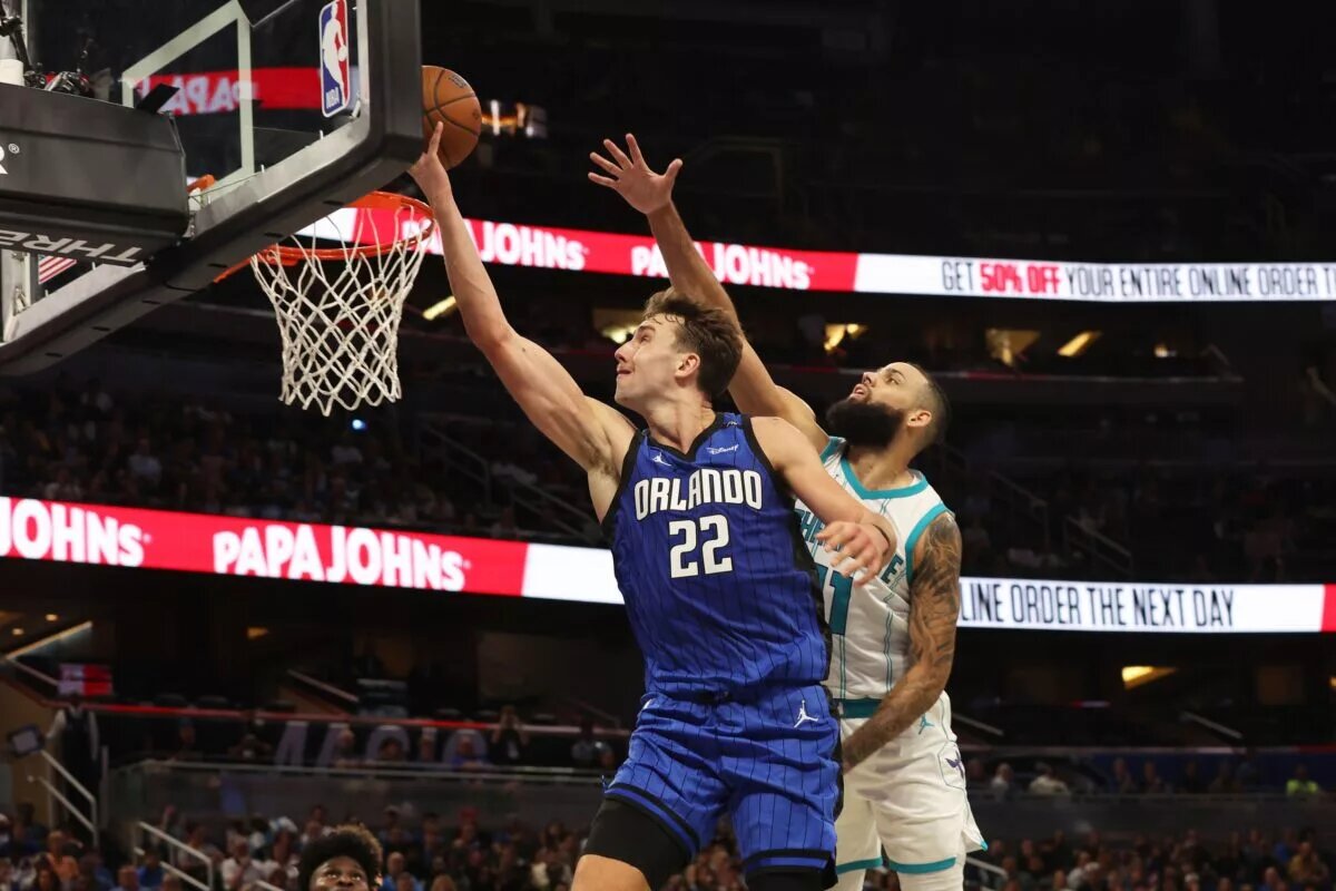 Nov 12, 2024; Orlando, Florida, USA; Orlando Magic forward Franz Wagner (22) shoots as Charlotte Hornets forward Cody Martin (11) defends during the second half at Kia Center. Mandatory Credit: Kim Klement Neitzel-Imagn Images