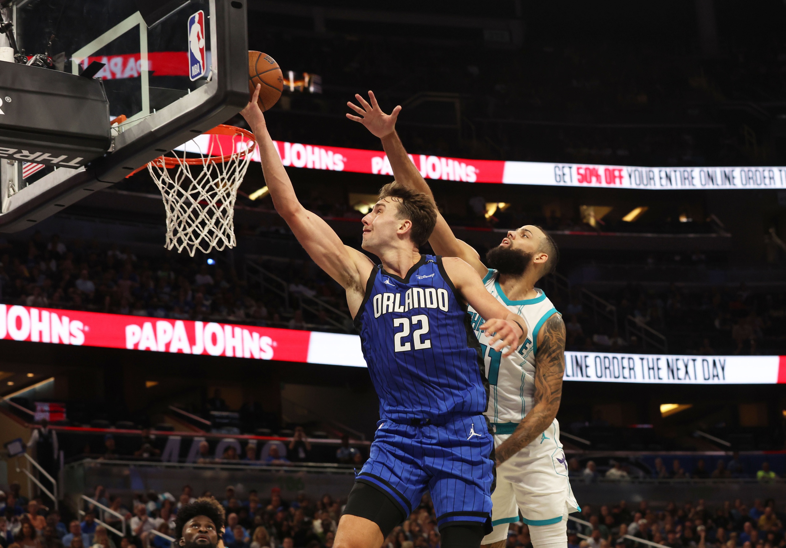 Nov 12, 2024; Orlando, Florida, USA; Orlando Magic forward Franz Wagner (22) shoots as Charlotte Hornets forward Cody Martin (11) defends during the second half at Kia Center. Mandatory Credit: Kim Klement Neitzel-Imagn Images