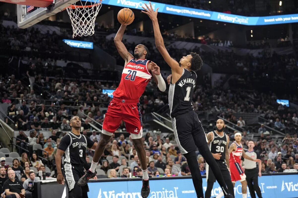 Nov 13, 2024; San Antonio, Texas, USA; Washington Wizards forward Alex Sarr (20) goes up to dunk while defended by San Antonio Spurs center Victor Wembanyama (1) during the second half at Frost Bank Center. Mandatory Credit: Scott Wachter-Imagn Images