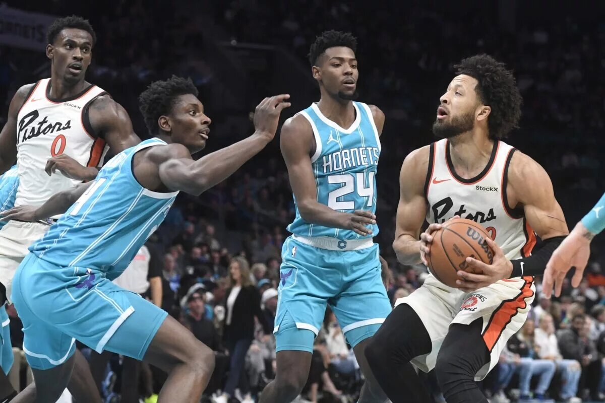 Nov 21, 2024; Charlotte, North Carolina, USA; Detroit Pistons guard Cade Cunningham (2) looks to shoot through the defense of the Charlotte Hornets during the first half at the Spectrum Center. Mandatory Credit: Sam Sharpe-Imagn Images