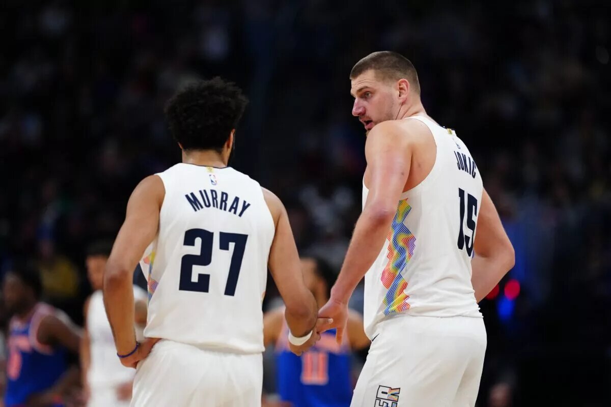 Nov 25, 2024; Denver, Colorado, USA; Denver Nuggets center Nikola Jokic (15) and guard Jamal Murray (27) during the second half against the New York Knicks at Ball Arena. Mandatory Credit: Ron Chenoy-Imagn Images