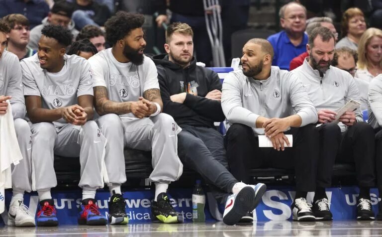 Dallas Mavericks guard Luka Doncic sits on the bench in street clothes during the first quarter against the LA Clippers at American Airlines Center.