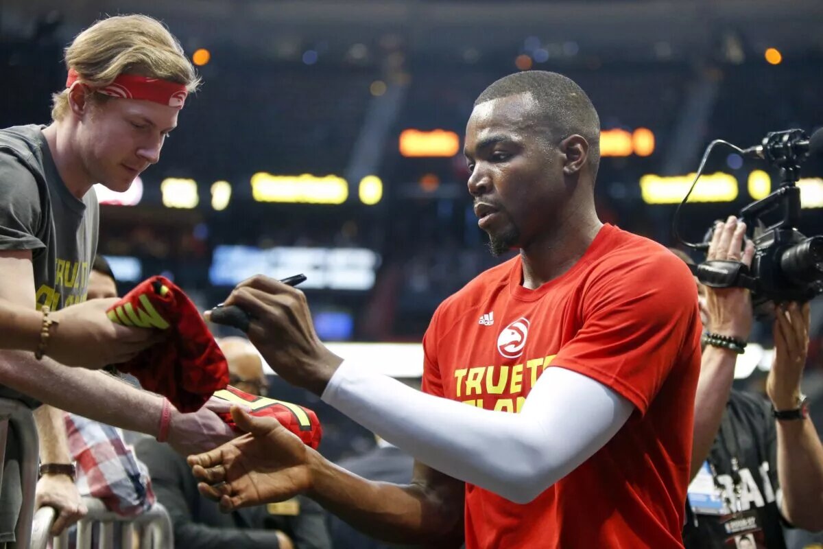 Atlanta Hawks forward Paul Millsap (4) signs autographs before a game