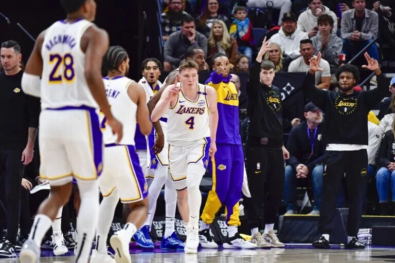 Los Angeles Lakers rookie Dalton Knecht (4) reacts after a three point basket