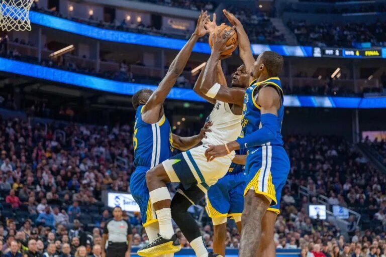 Minnesota Timberwolves guard Anthony Edwards (5) shot is blocked by Golden State Warriors forward Jonathan Kuminga (00) and forward Draymond Green (23)