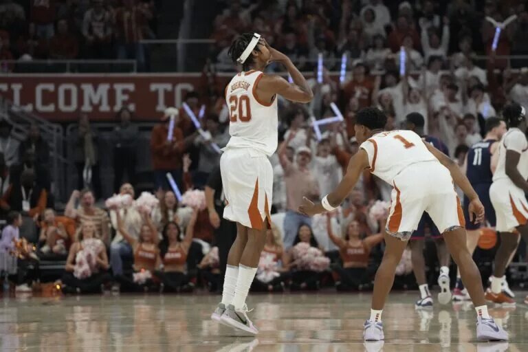 Texas Longhorns guard Tre Johnson (20) reacts after scoring a three point basket