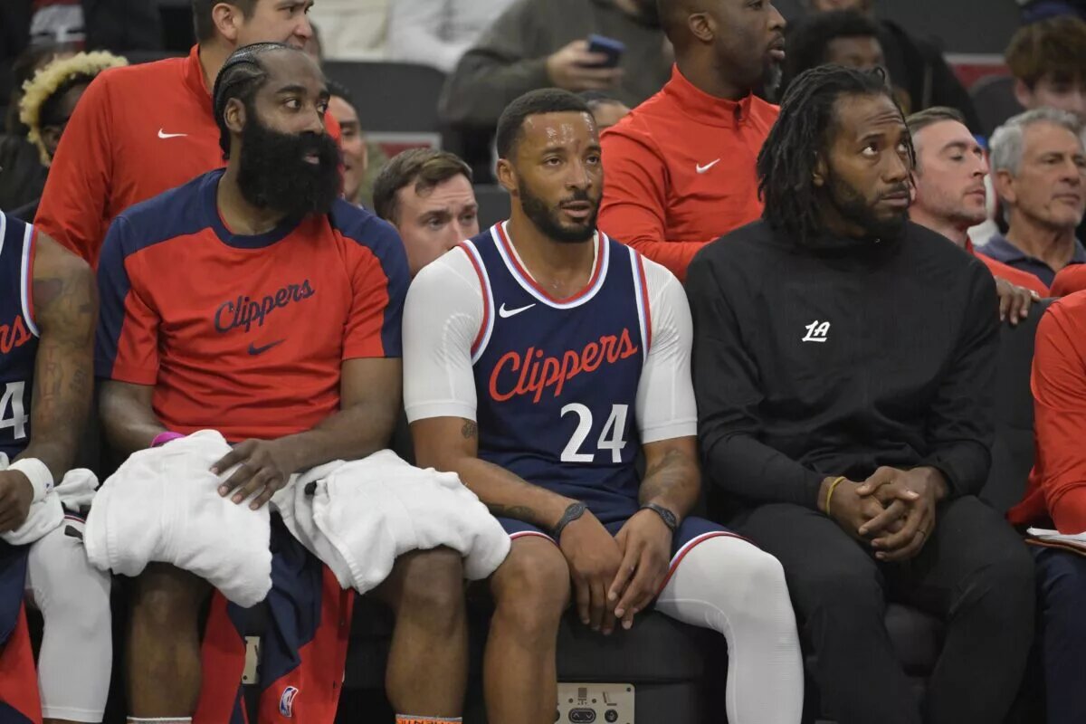 Los Angeles Clippers guard James Harden (1), guard Norman Powell (24) and forward Kawhi Leonard (2) look on from the bench