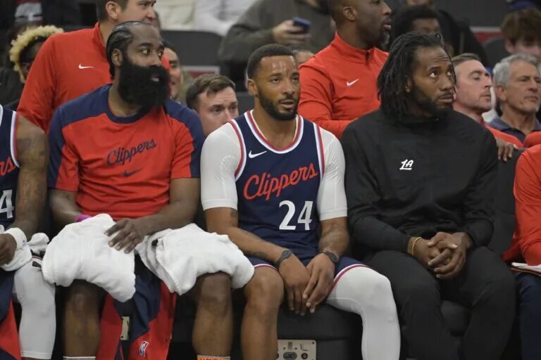 Los Angeles Clippers guard James Harden (1), guard Norman Powell (24) and forward Kawhi Leonard (2) look on from the bench