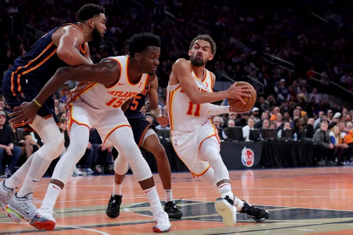 Atlanta Hawks guard Trae Young (11) drives to the basket against New York Knicks center Karl-Anthony Towns (32) and forward Mikal Bridges (25) as Hawks center Clint Capela (15) sets a pick