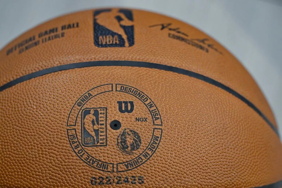 A view an NBA Wilson basketball with the NBA logo and Dallas Mavericks logo