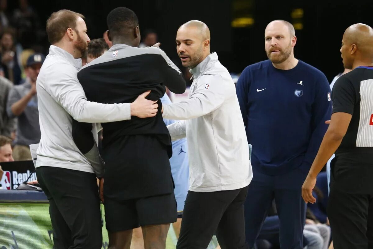 Brooklyn Nets head coach Jordi Fernandez (middle) and guard Dennis Schroder (17) interact with Memphis Grizzlies head coach Taylor Jenkins (right)