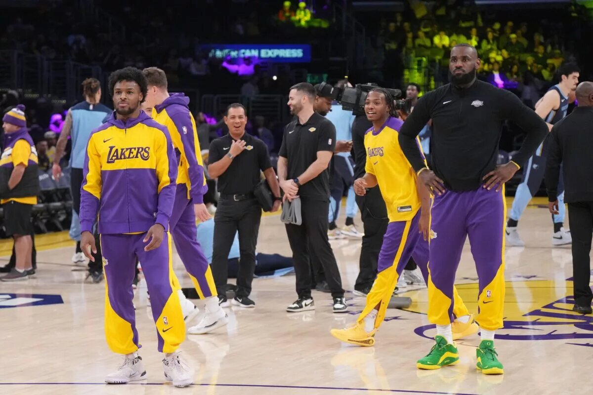 Los Angeles Lakers forward LeBron James (right) and son Bronny James during the game