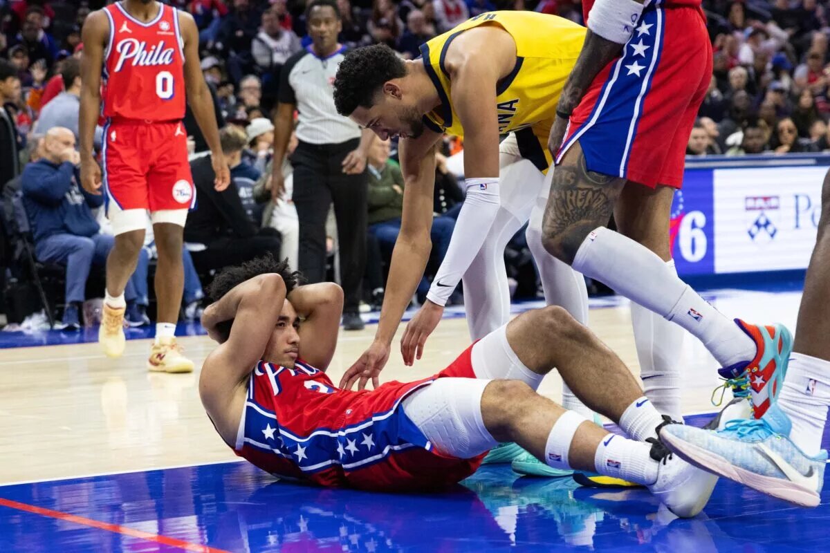 Philadelphia 76ers guard Jared McCain (20) holds his head