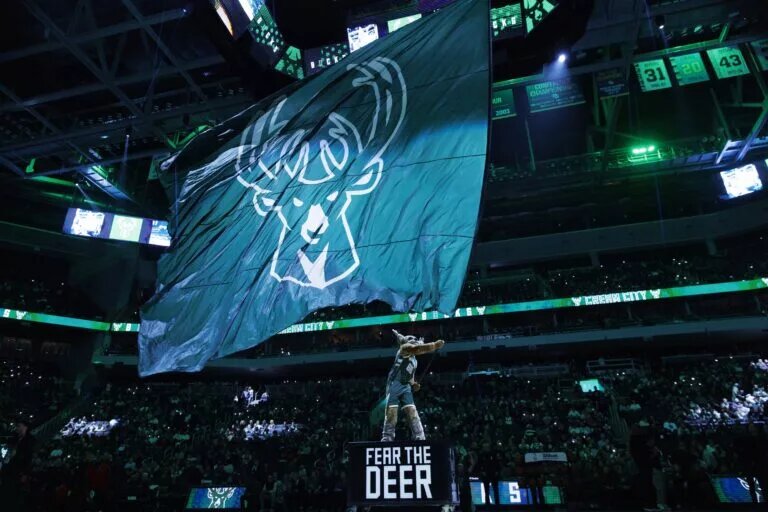Milwaukee Bucks mascot Bango waves flag with the Milwaukee Bucks logo