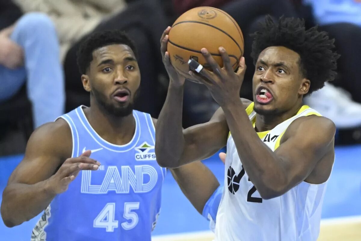 Utah Jazz guard Collin Sexton (2) drives to the basket beside Cleveland Cavaliers guard Donovan Mitchell (45)