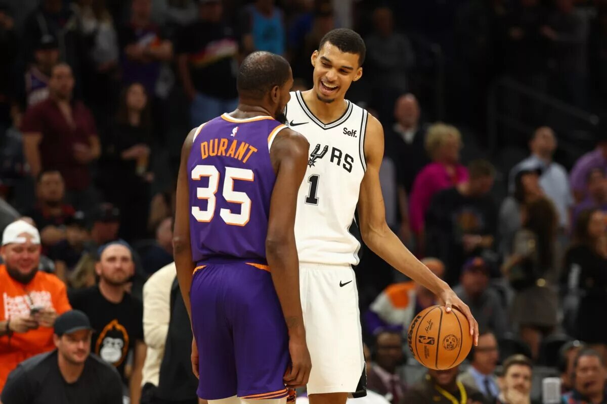 San Antonio Spurs center Victor Wembanyama (1) talks with Phoenix Suns forward Kevin Durant (35)