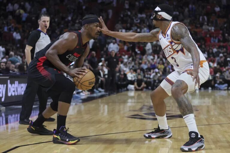 Miami Heat forward Jimmy Butler (22) is guarded by Phoenix Suns guard Bradley Beal (3)