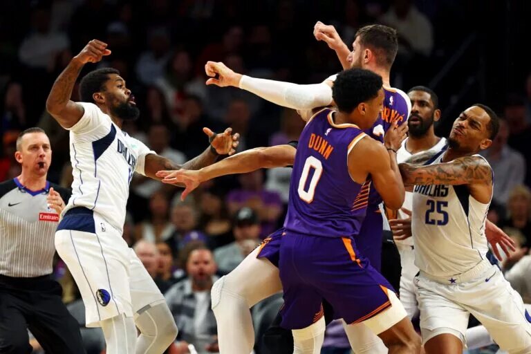 Dallas Mavericks forward Naji Marshall (13) punches Phoenix Suns center Jusuf Nurkic (20)