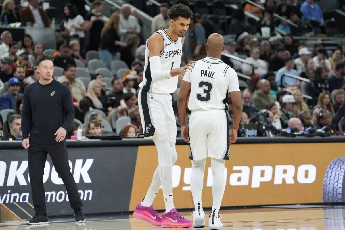 San Antonio Spurs center Victor Wembanyama (1) talks with guard Chris Paul (3)
