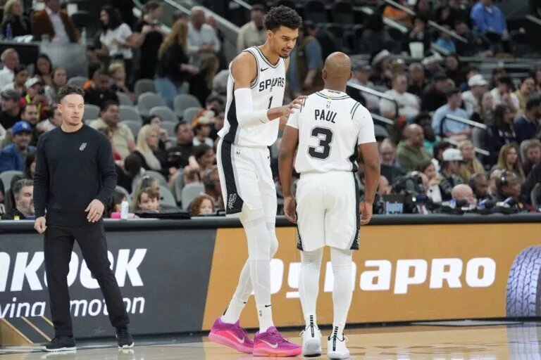 San Antonio Spurs center Victor Wembanyama (1) talks with guard Chris Paul (3)