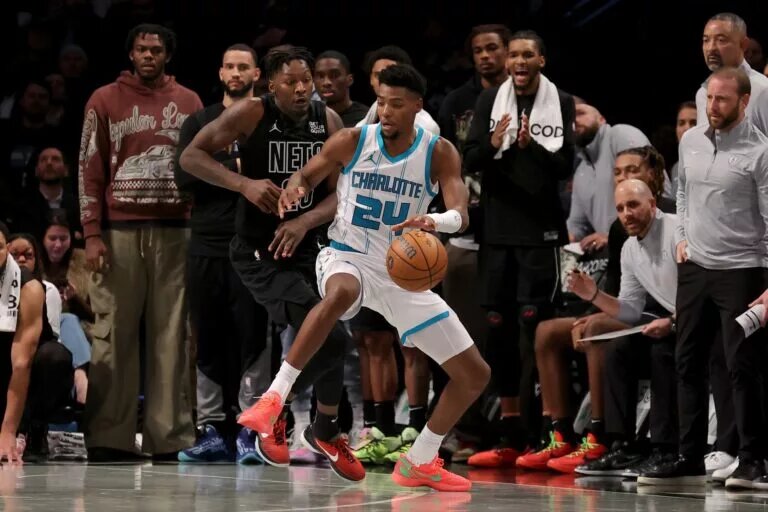 Charlotte Hornets forward Brandon Miller (24) controls the ball against Brooklyn Nets forward Dorian Finney-Smith (28)