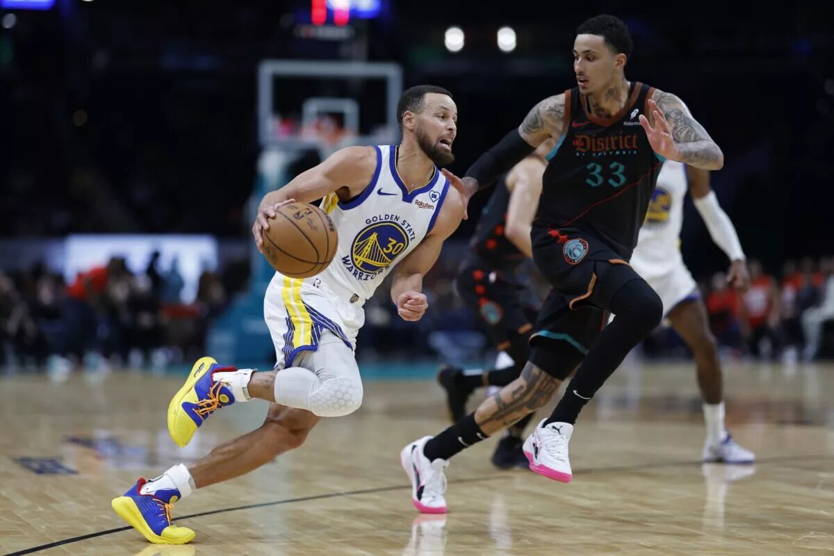 Feb 27, 2024; Washington, District of Columbia, USA; Golden State Warriors guard Stephen Curry (30) drives to the basket as Washington Wizards forward Kyle Kuzma (33) defends in the second half at Capital One Arena. Mandatory Credit: Geoff Burke-USA TODAY Sports