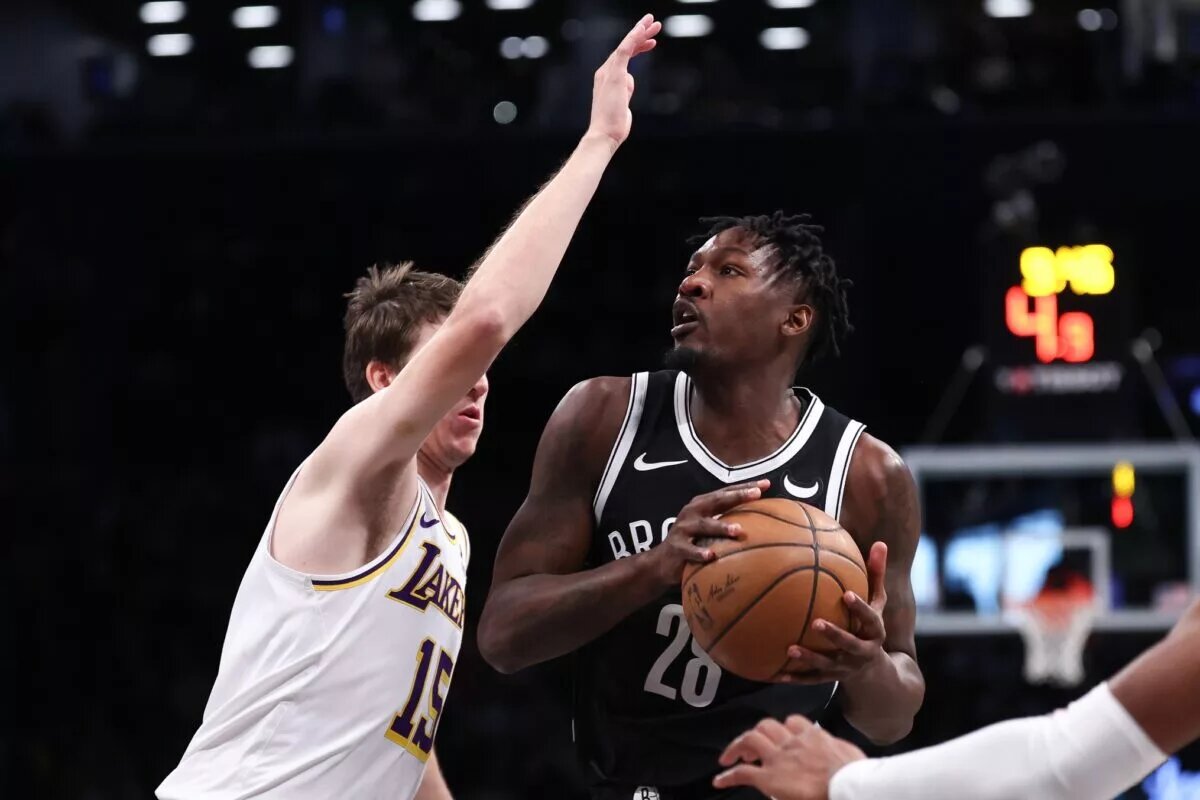 Mar 31, 2024; Brooklyn, New York, USA; Brooklyn Nets forward Dorian Finney-Smith (28) looks to the basket against Los Angeles Lakers guard Austin Reaves (15) during the first quarter at Barclays Center. Mandatory Credit: Vincent Carchietta-USA TODAY Sports