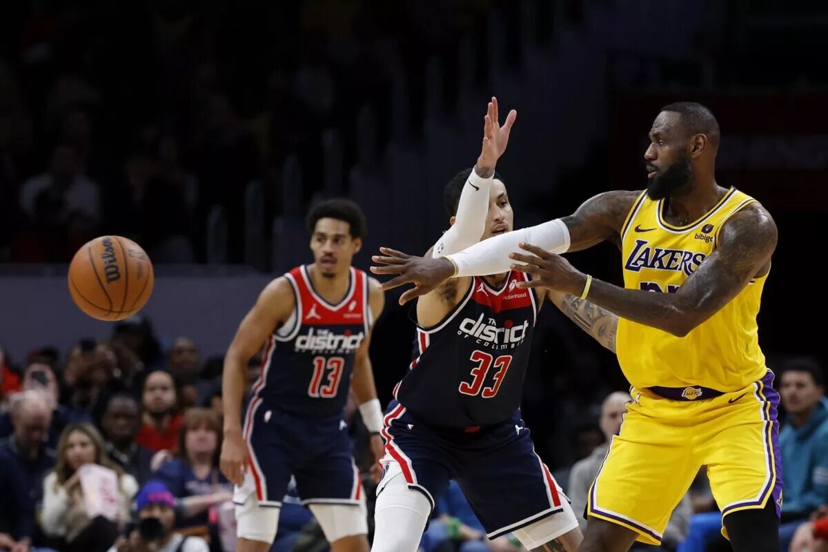 Apr 3, 2024; Washington, District of Columbia, USA; Los Angeles Lakers forward LeBron James (23) passes the ball as Washington Wizards forward Kyle Kuzma (33) defends at Capital One Arena. Mandatory Credit: Geoff Burke-USA TODAY Sports