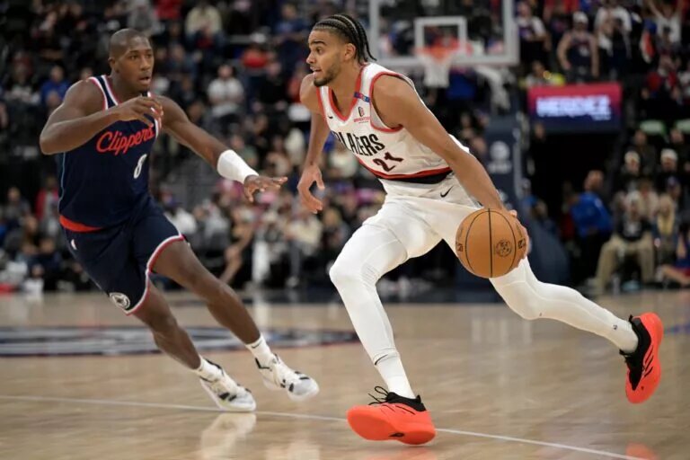 Oct 30, 2024; Inglewood, California, USA;Portland Trail Blazers guard Rayan Rupert (21) is defended by Los Angeles Clippers guard Kris Dunn (8) in the second half at Intuit Dome. Mandatory Credit: Jayne Kamin-Oncea-Imagn Images