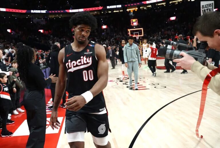 Nov 17, 2024; Portland, Oregon, USA; Portland Trail Blazers guard Scoot Henderson (00) poses for the camera after the Trail Blazers defeat Atlanta Hawks 114-110 in the second half at Moda Center. Mandatory Credit: Jaime Valdez-Imagn Images