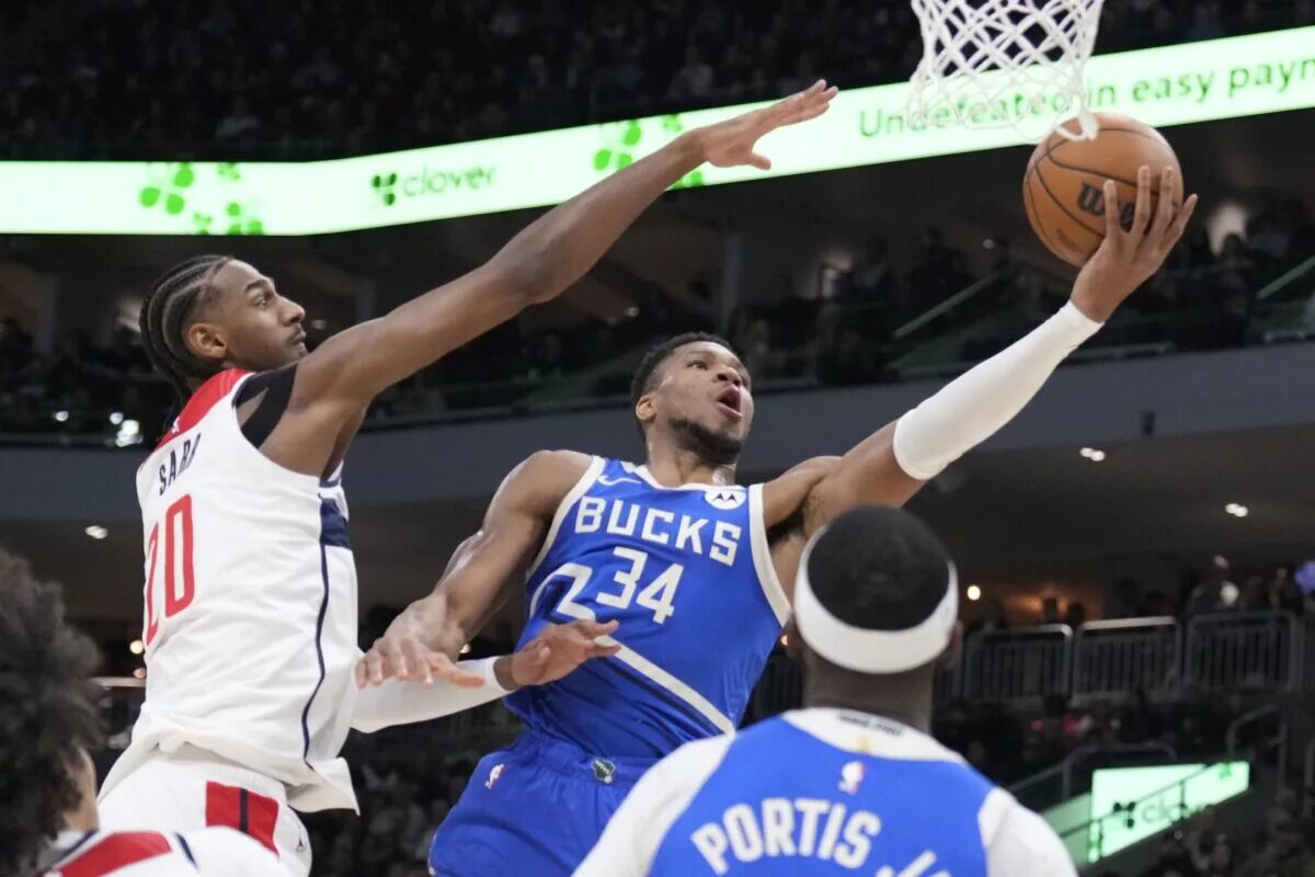 Nov 30, 2024; Milwaukee, Wisconsin, USA; Milwaukee Bucks forward Giannis Antetokounmpo (34) drives to the basket against Washington Wizards forward Alexandre Sarr (20) in the first half at Fiserv Forum. Mandatory Credit: Michael McLoone-Imagn Images