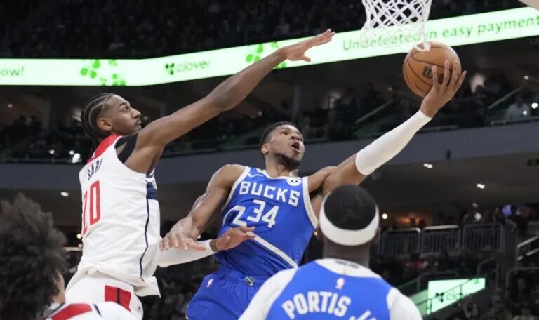 Nov 30, 2024; Milwaukee, Wisconsin, USA; Milwaukee Bucks forward Giannis Antetokounmpo (34) drives to the basket against Washington Wizards forward Alexandre Sarr (20) in the first half at Fiserv Forum. Mandatory Credit: Michael McLoone-Imagn Images